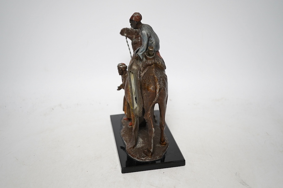 An Austrian cold painted bronze lighter in the form of a camel and two figures, approximately 17cm wide. Condition - worn in places, unchecked if working